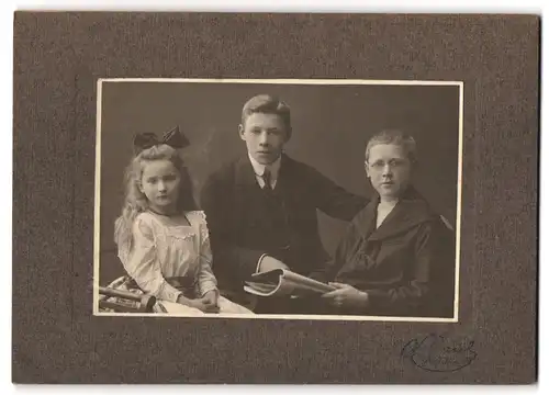 Fotografie Atelier Schulz, Altona, Bursche in Marineuniform m. Brille nebst Schwester mit Haarschleife & Bruder im Anzug