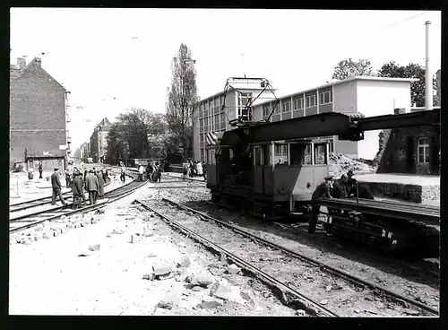 Fotografie Lambertin, Köln, Ansicht Köln, Strassenbahn-Baustelle, Gleisarbeiter verlegen Schienen mit Kranwagen der KVB