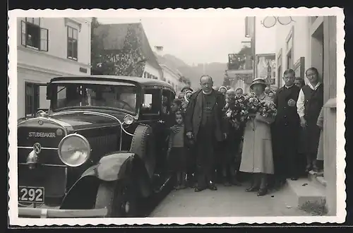 Foto-AK Auto Studebaker (1928 /29), Paar mit Rosenstrauss und Familie und Freunde nebst Wagen