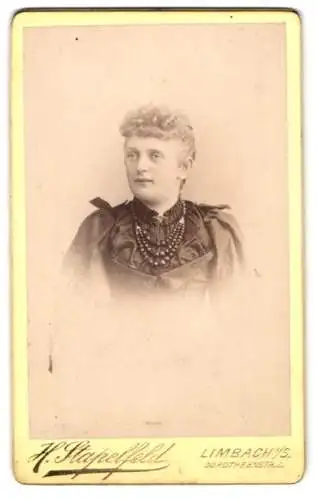 Fotografie H. Stapelfeld, Limbach i. S., Dorotheenstr. 8, Junge Frau mit lockigem Haar im schwarzen Kleid