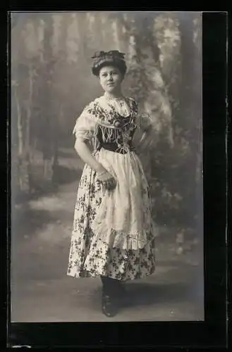 Foto-AK Frau im geblümten Kleid in einer Studiokulisse
