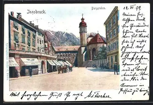 Künstler-AK Innsbruck, Strasse am Burggraben mit Geschäften und Kirche
