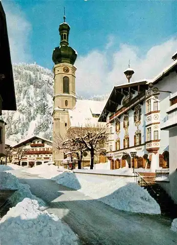 AK / Ansichtskarte Reit Winkl Gasthof Pension Unterwirt Ortsstrasse Kirche im Winter Kat. Reit im Winkl