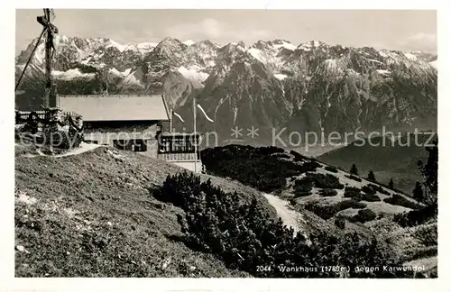 AK / Ansichtskarte Wankhaus Gipfelkreuz Berghuette gegen Karwendelgebirge Kat. Garmisch Partenkirchen