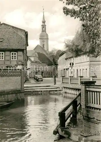 AK / Ansichtskarte Luebbenau Spreewald Partie am Wasser Blick zur Kirche Kat. Luebbenau