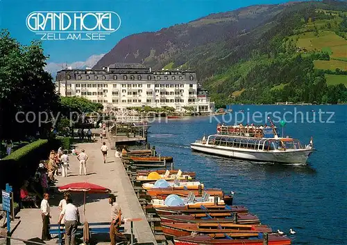 AK / Ansichtskarte Zell See Seepromenade mit Grand Hotel und Schiffsanlegeplaetzen Kat. Zell am See