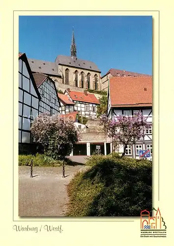 AK / Ansichtskarte Warburg_Westfalen Altstadt Fachwerkhaeuser Baumbluete Kirche Warburg_Westfalen Kat. Warburg