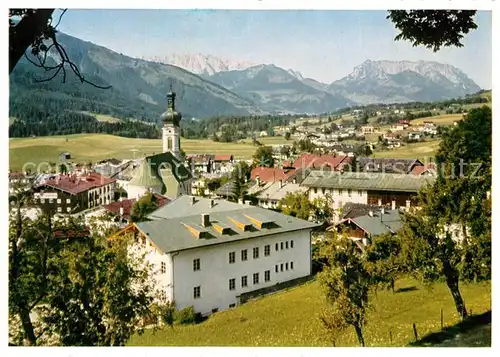 AK / Ansichtskarte Reit_Winkl Ortsansicht mit Kirche Blick zum Kaisergebirge Reit_Winkl