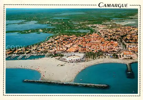 AK / Ansichtskarte Les_Saintes Maries de la Mer La ville les Arenes la plage Le port de plaisance Vue aerienne Les