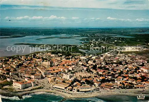 AK / Ansichtskarte Les_Saintes Maries de la Mer Vue aerienne du village lEglise et lEtang des Launes Les