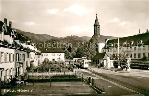 AK / Ansichtskarte Guenterstal_Freiburg Strassenbahn mit Kirche Guenterstal_Freiburg