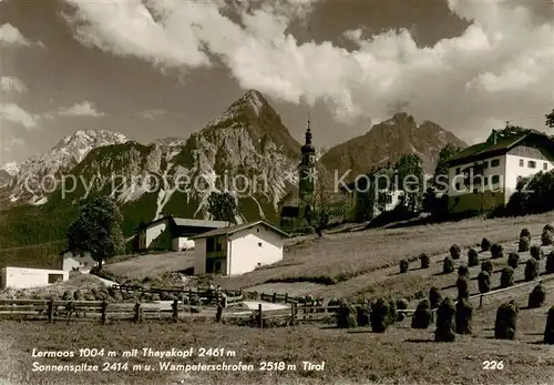 AK / Ansichtskarte 73813673 Lermoos_Tirol_AT Ortsansicht mit Kirche Blick gegen Thayakopf Sonnenspitze Wamperter Schrofen 